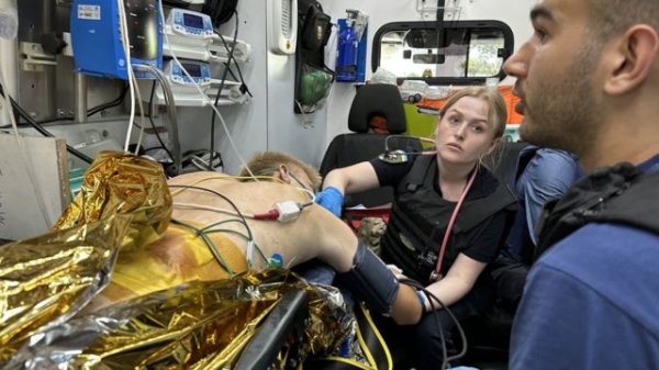 Dr Dmityr treating Oleh in the back of an ambulance